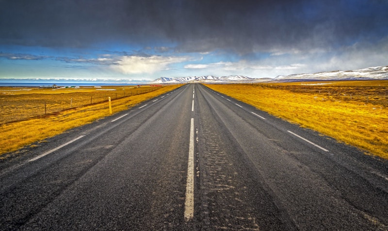 A straight road ahead with mountains off to the
distance